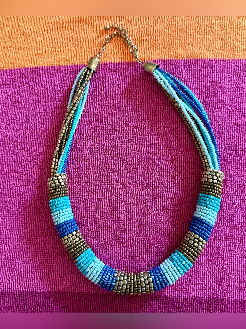 Neckless, made from tiny beads. Different shade of blue, gold & bronze